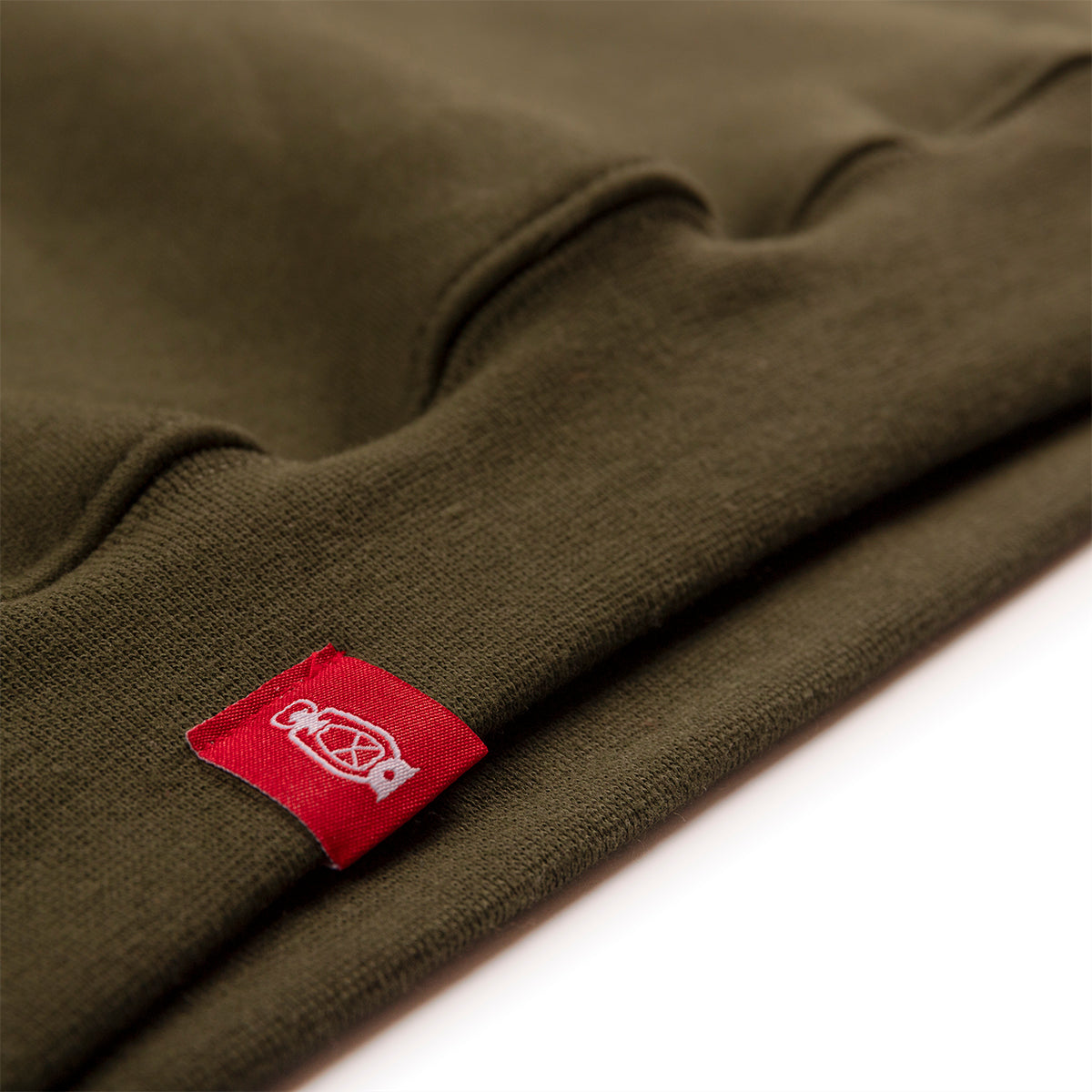 The Hoodie No.1 by Dark Forest in olive green with red woven label detail shot