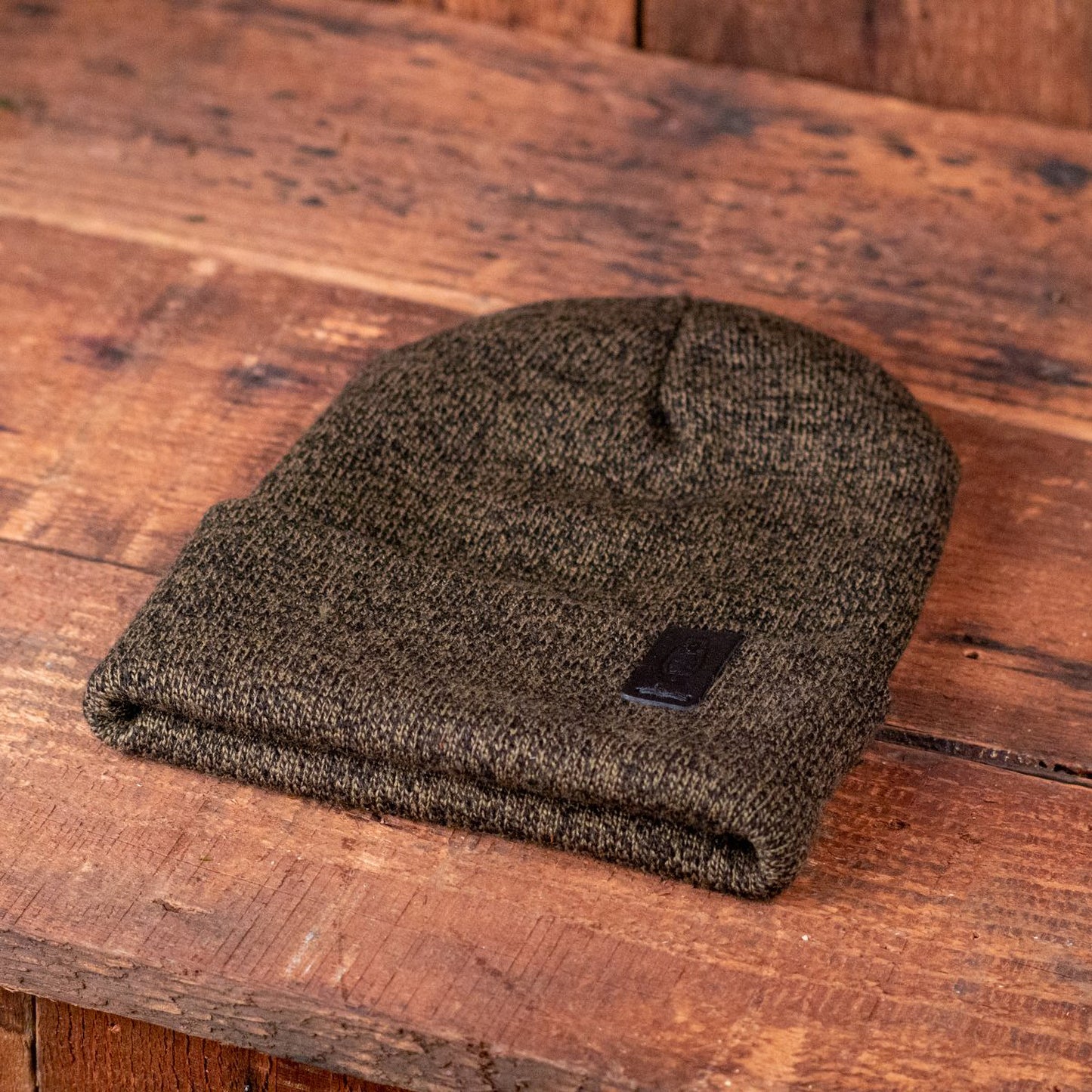 Detail of the Standard Knit Watch Cap by Dark Forest with leather logo