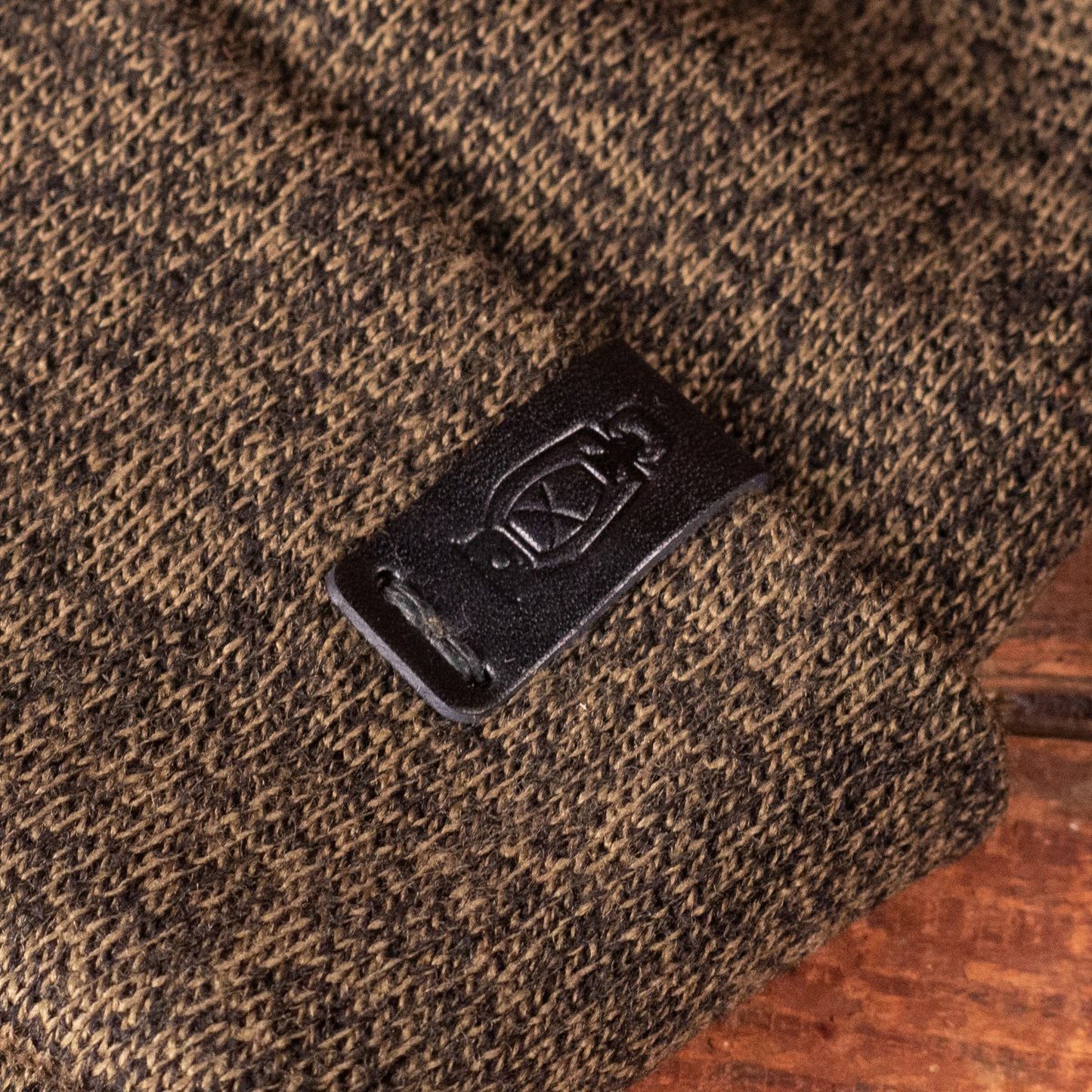 Leather logo detail of the Standard Knit Watch Cap by Dark Forest