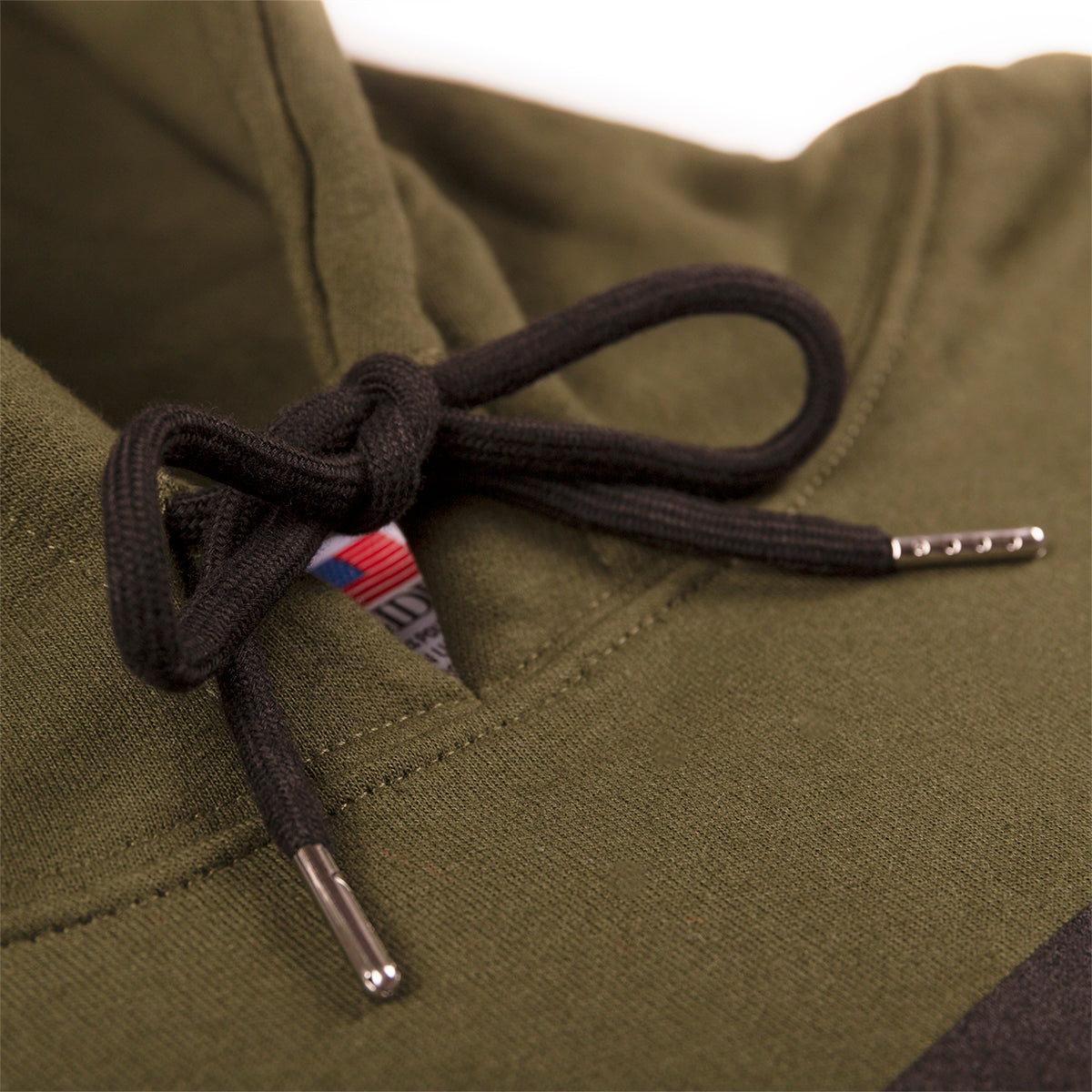The Hoodie No.1 by Dark Forest in olive green with red woven label detail pull strings