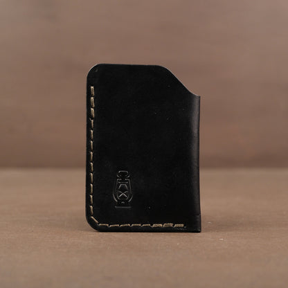 Black minimalist full grain leather card wallet made in usa with veg tan leather