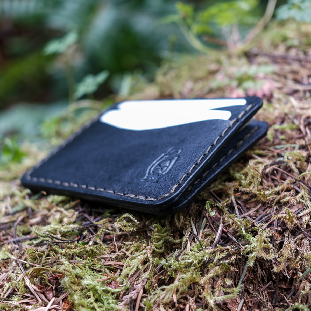 Black minimalist card wallet made from full grain veg tan leather